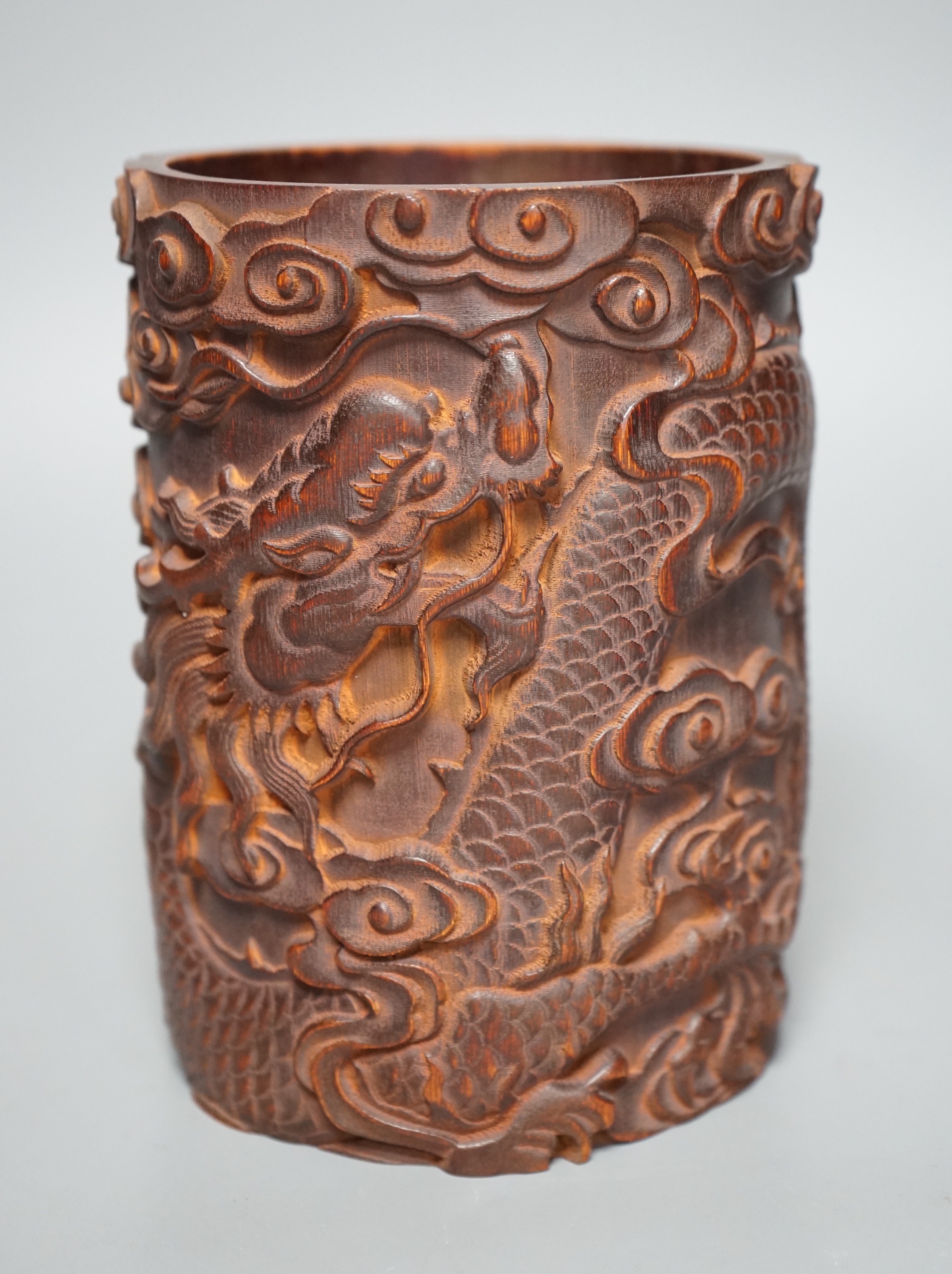 A Chinese ‘dragon’ carved bamboo brushpot, 17cm